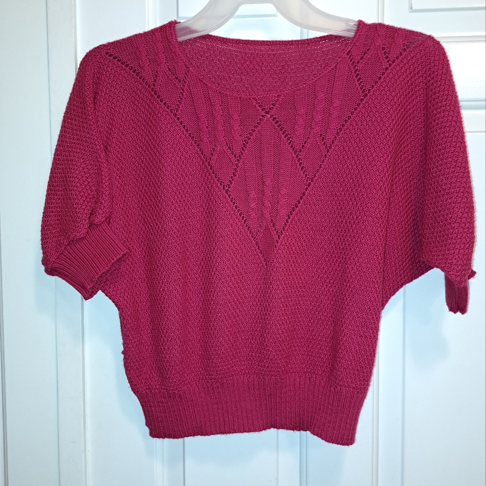 Fuscia Pink batwing knit sweater with cut out design under a scoop neck. Size L